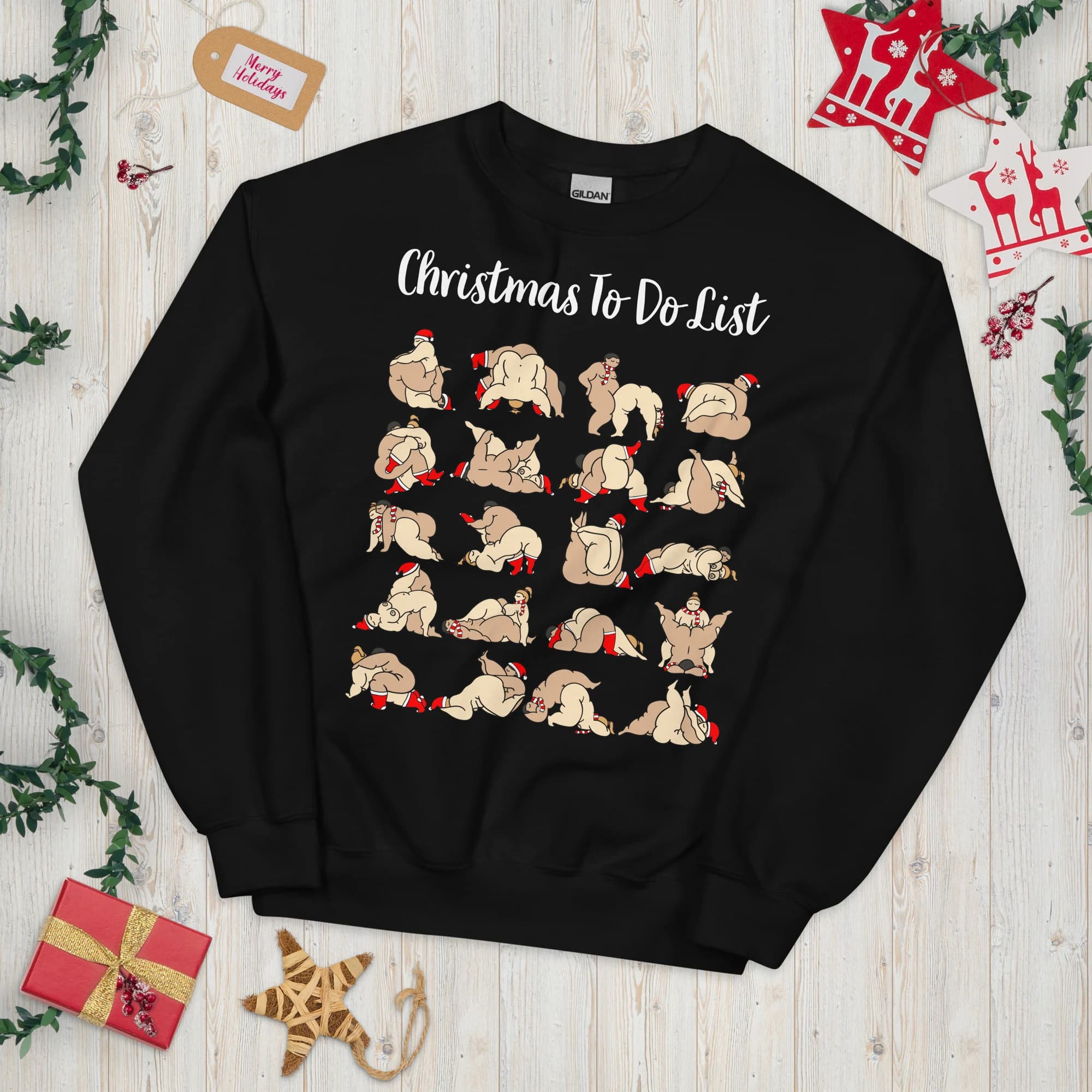 Black unisex Christmas sweatshirt featuring a grid of cheeky illustrated adult couples wearing Christmas accessories. Wording shown is a customizable example.