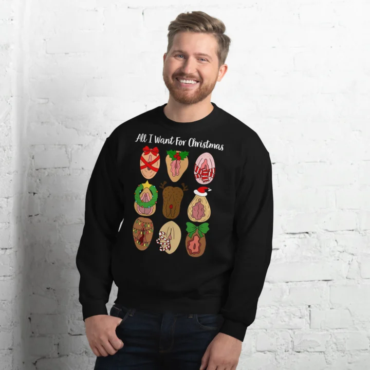 Person wearing a black crewneck sweatshirt with nine festive vulva illustrations and sample 'All I Want For Christmas' text.